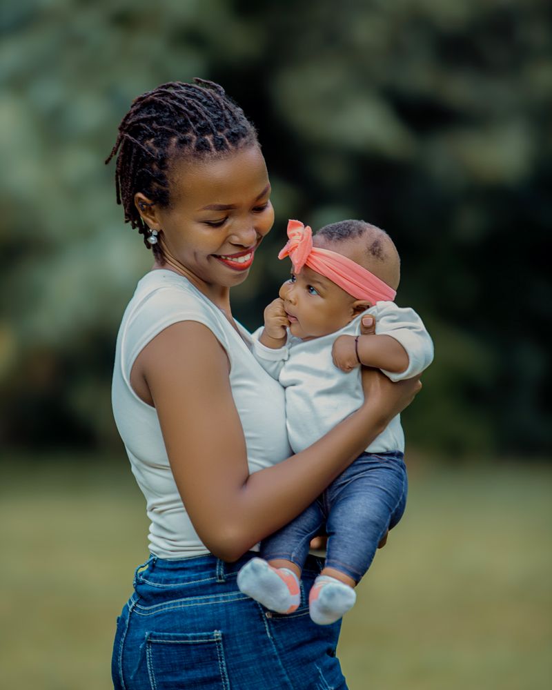 Mother holding her baby outdoors