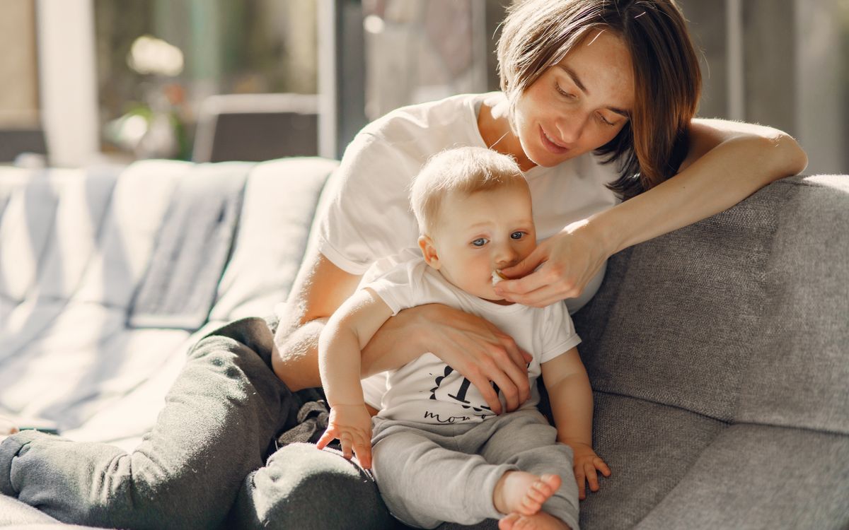 Mother relaxing on the sofa with her baby