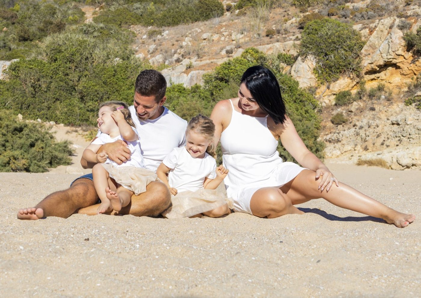 Family sitting together on the beach