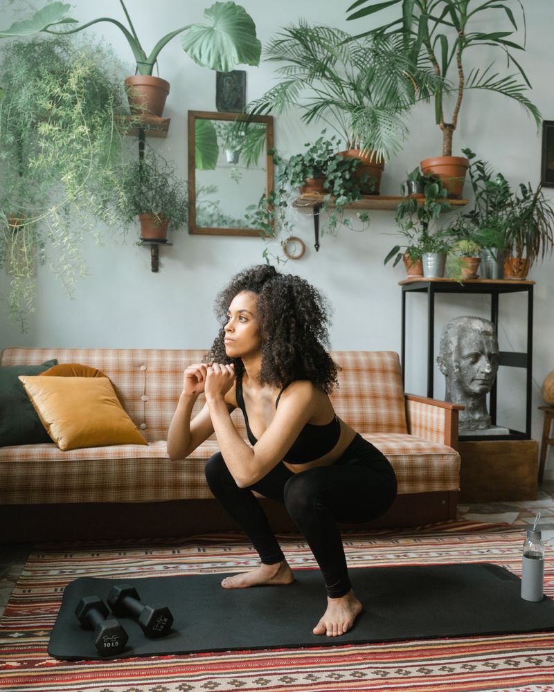 Woman doing a squat in her living room